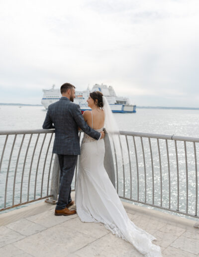 married couple share a moment with a beautiful view of the port in portsmouth happy love