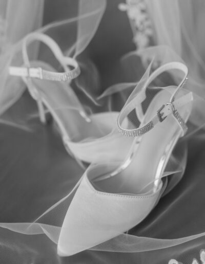 Brides shoes draped with the veil