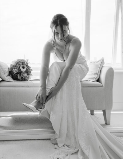 Classic photograph of a bride getting her shoes on