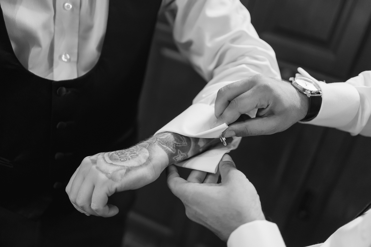 Groom is getting dressed before the ceremony