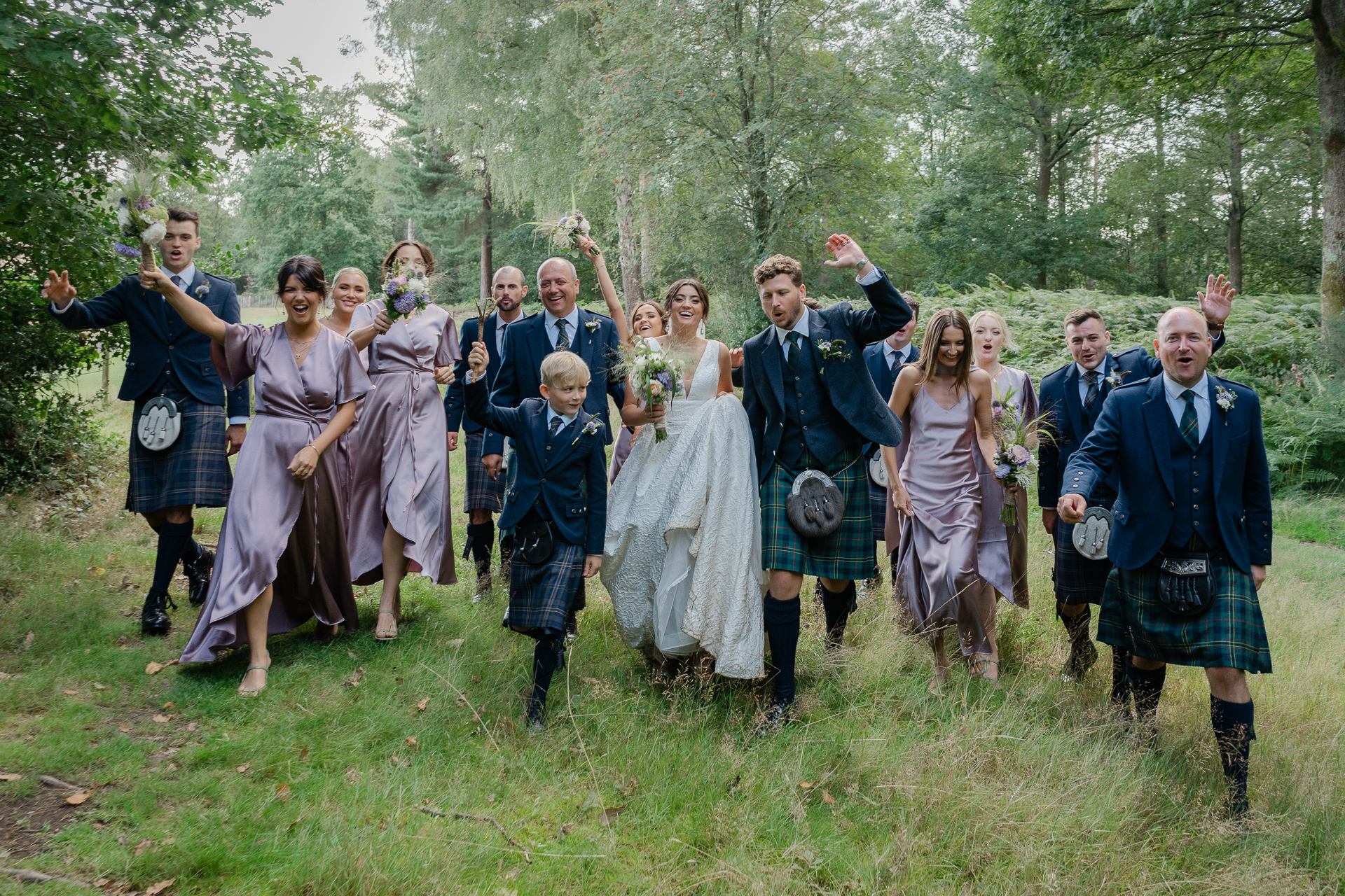 Large bridal party having fun during their group photos at a wedding