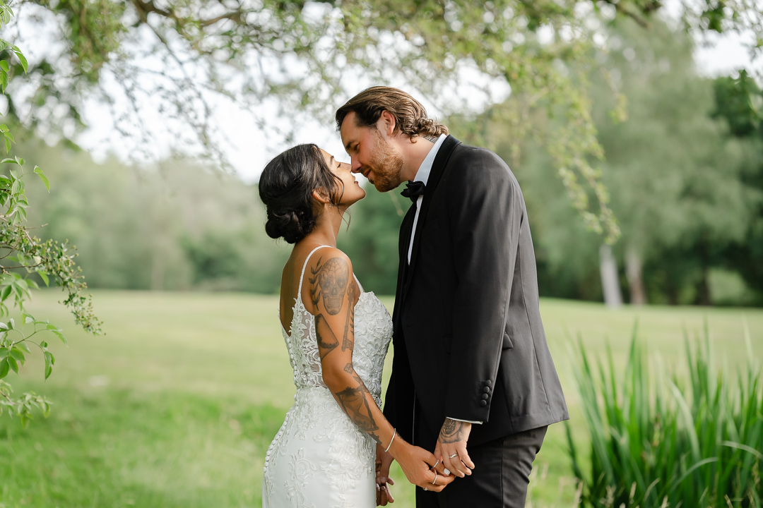 gorgeous couple embracing love at the beautiful grounds of the Warren Estate Maldon