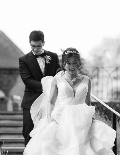 bride leads groom down stairs during their portrait session