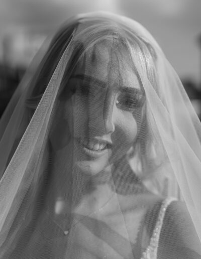 Beautiful bride smiling with her veil and beautiful sunlight