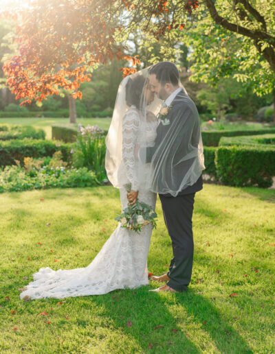 Bride and groom have a kiss at golden hour