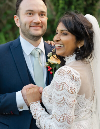 Bride and groom smile while taking a photo